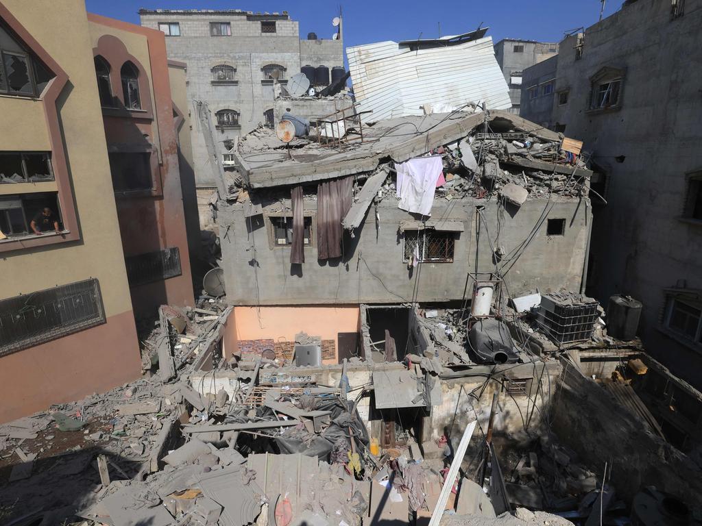 Palestinians inspect the damage to a building after Israeli strikes, in Khan Yunis in the southern Gaza Strip on October 14, 2023. Pictures AFP.