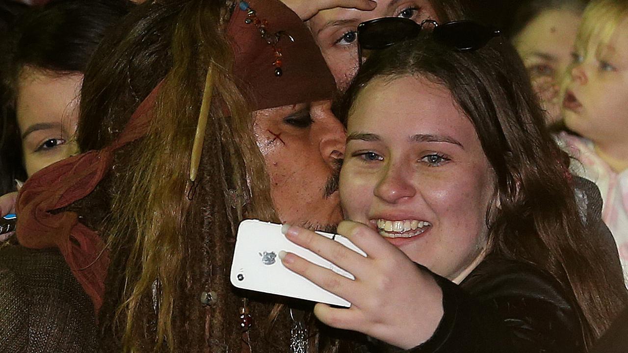 Depp kisses a fan who waited several hours to see him on the Gold Coast. Picture: Regi Varghese