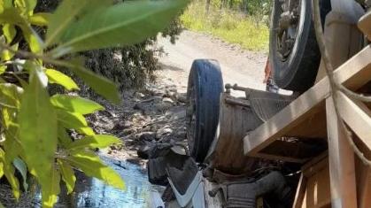 A worker had a lucky escape after its vehicle rolled over in a dam at a Bloomsbury property. Picture: RACQ CQ Rescue