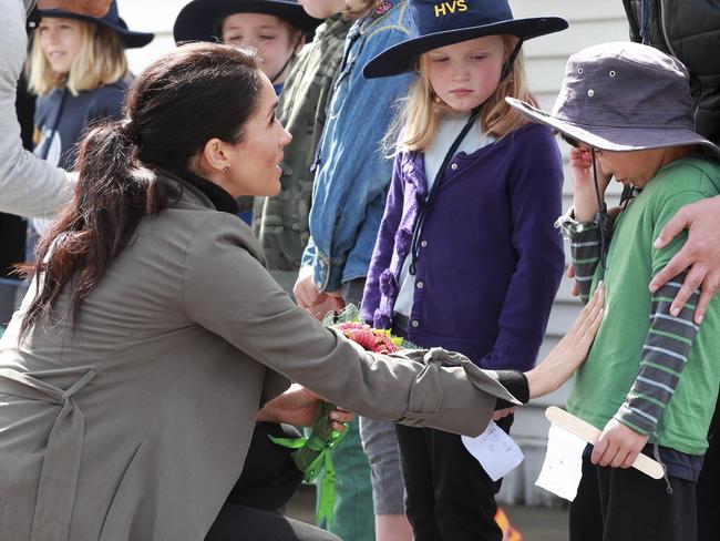 A caring Meghan consoles overwhelmed pupil Joe Young in Wellington. Picture: AP