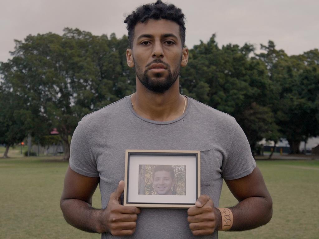 Brisbane Lions AFL player Archie Smith with a photo of his 21-year-old brother Sebastian, who died to suicide last year.