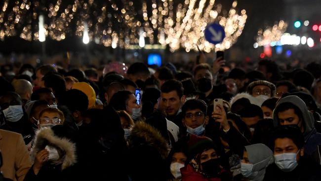 People gather on the Unter den Linden boulevard close to Brandenburg Gate in Berlin to catch a glimpse of the fireworks on New Year's Eve, December 31, 2021. Picture: AFP