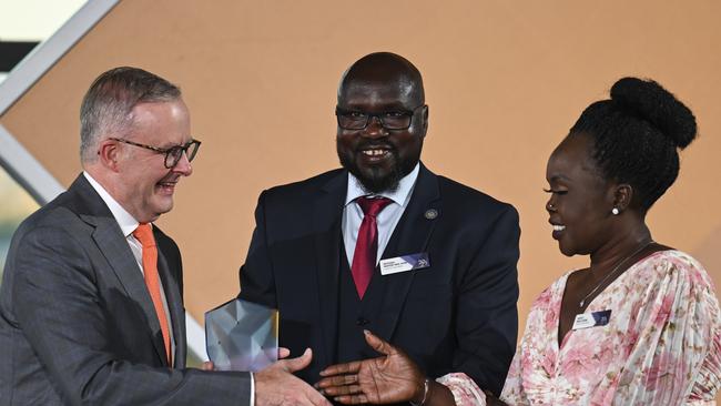 Anthony Albanese presents the Young Australian of the Year award to Awer Mabil’s mother and uncle. Picture: Getty