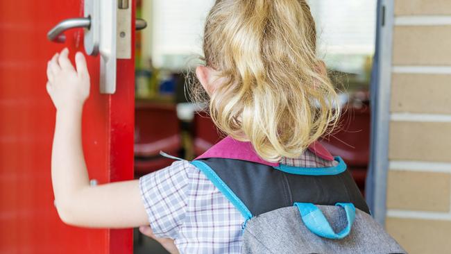 Kindergarten primary school student arriving to class for her first day of education