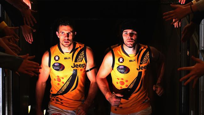 Brett Deledio of the Tigers (L) and Trent Cotchin lead the team out at half time during Dreamtime at the ‘G between Richmond and Essendon.