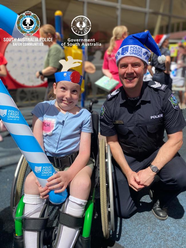 Georgie and Sergeant Wood enjoying the police party. Picture: SA Police