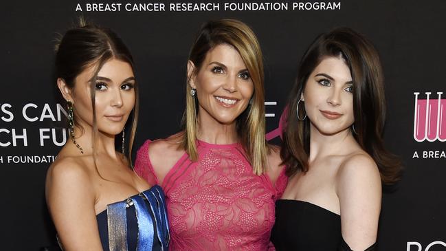 Actress Lori Loughlin, centre, poses with daughters Olivia Jade Giannulli, left, and Isabella Rose Giannulli. (Photo by Chris Pizzello/Invision/AP, File)