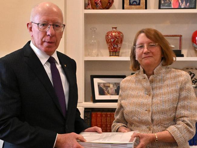 Commissioner Catherine Holmes hands her report to Governor-General David Hurley.