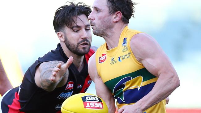 SANFL - Second Semi-Final - Eagles v West Adelaide at Adelaide Oval. James Boyd gets his handpass away from the out stretched arm of Adam Hartlett. Photo Sarah Reed.