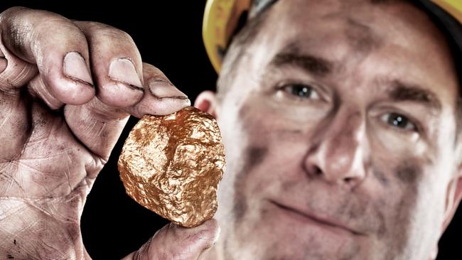 A gold miner shows a golden hugget freshly excavated from a mine.