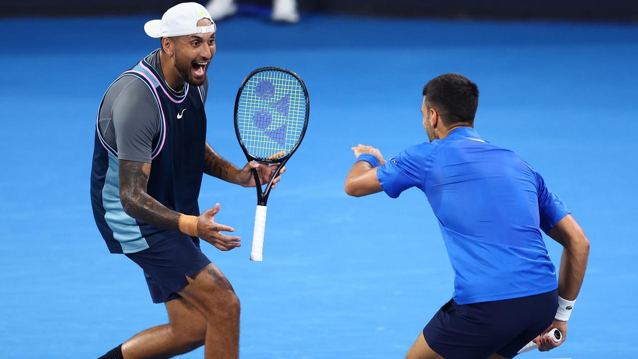 Nick Kyrgios and Novak Djokovic celebrate a point.