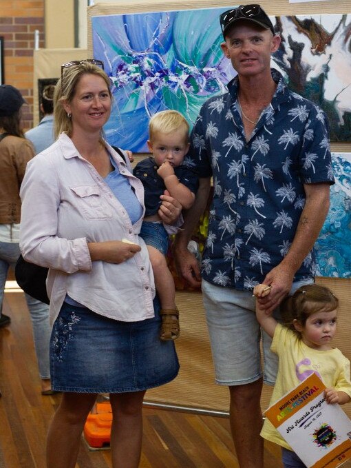 The Kay family checks out the art at the Moore Park Beach Arts Festival.