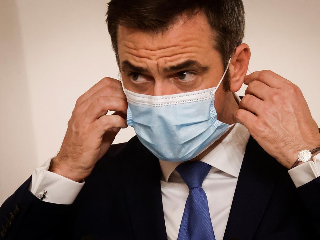 French Health Minister Olivier Veran takes off his protective face mask to deliver a speech during a press conference announcing the changeover of several departments to "maximum alert" and new curfew measures in order to curb the spread of the virus. Picture: Ludovic Marin/AFP