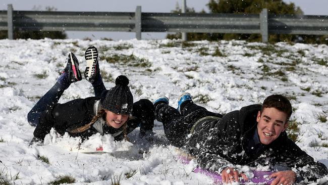 Tori Saville 17 of Mount Nelson, left, and Hugh Willaims 19 of Pontville boogie-boarding next to the Southern Outlet in Mount Nelson