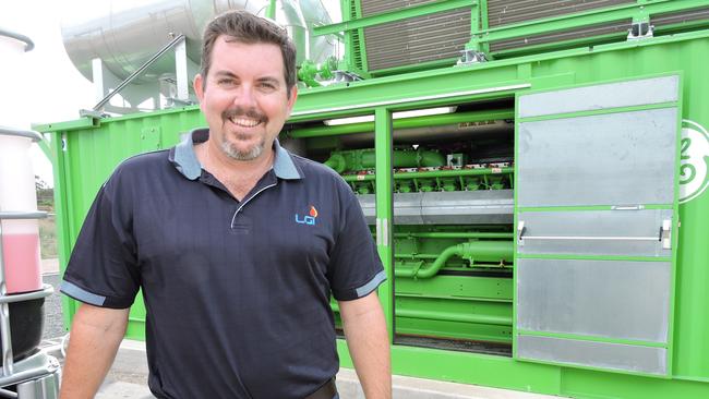 Landfill Gas Industries managing director Adam Bloomer stands in front of the $3 million biogas engine.