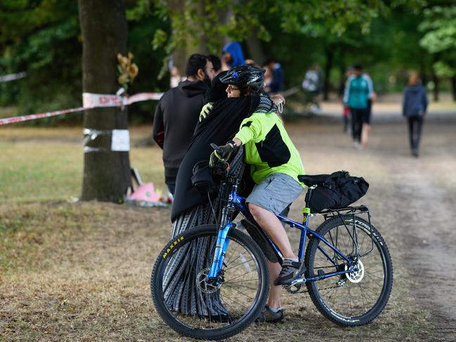 A member of the Muslim community is comforted by a passer-by near Al Noor mosque in Christchurch. Picture: Getty 