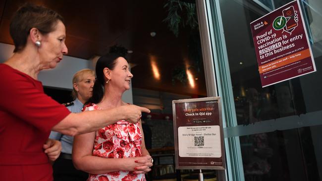 Queensland Health Minister Yvette D'Ath (right) and Small Business Minister Di Farmer look at a sign informing patrons they must be vaccinated to enter the premises. Picture: Dan Peled (NCA NewsWire)