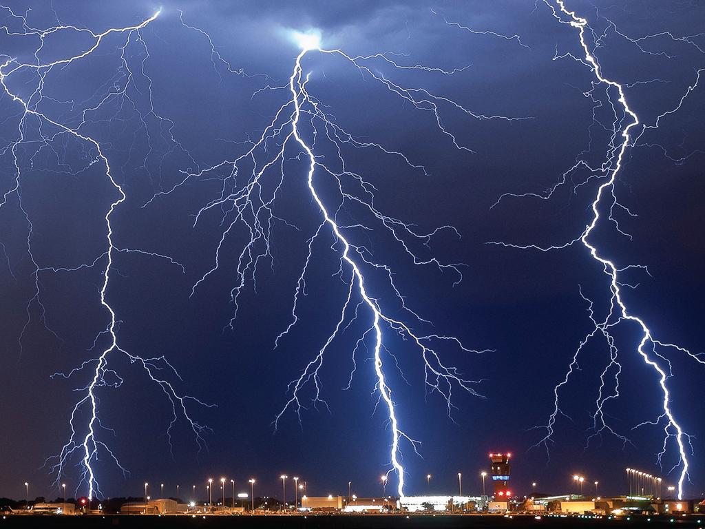 December: Lightning over Adelaide Airport, South Australia. Photograph: Rowland Beardsell. A night shift at Adelaide Airport Met Office in March 2013 let Rowland Beardsell combine his job as a Bureau of Meteorology weather observer with his passion for storm photography. A thunderstorm was expected so he set up his camera on the Met Office balcony with a timer set to begin a new exposure every 20 seconds. While working, he saw a bright flash and raced out,’ he says, ‘and sure enough there it was on the camera’—he had captured not one lightning bolt, but three simultaneous strikes.