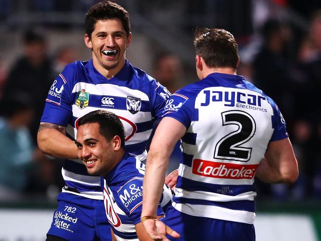 Jeremy Marshall-King and Brett Morris celebrate with Reimis Smith after a try.