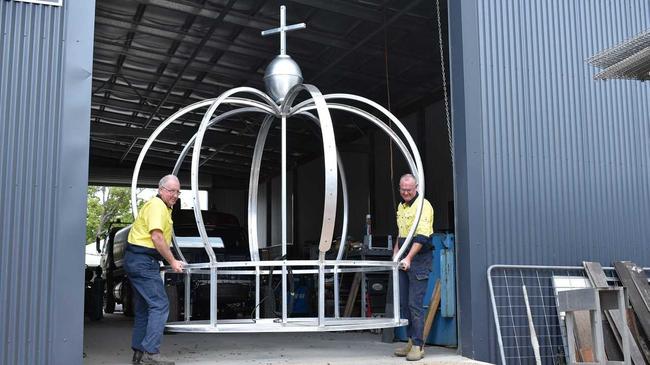 Electrician John Hough and Tony Blackadder from Grafton Ally Fabrications put the finishing touches to the new Jacaranda Queen Clocktower crown. Picture: Jenna Thompson