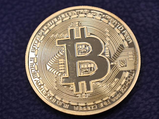 This photograph taken on December 17, 2020 shows shows a physical imitation of a Bitcoin at a crypto currency "Bitcoin Change" shop, near Grand Bazaar, in Istanbul. - Leading virtual currency bitcoin on 16 December traded above $20,000 for the first time following a sustained run higher in recent weeks. Bitcoin reached a record-high $20,398.50 before pulling back to $20,145, which was still an intra-day gain of nearly four percent. (Photo by Ozan KOSE / AFP)