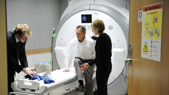 John Marshall, Parkinson`s disease patient involved in clinical trial at the Brain &amp; Mind Research Institute, Camperdown . ( Karen Chisnell, radiographer and Dr Samuel Bolitho assist patient John Marshall)