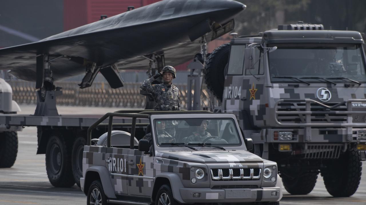 A Chinese soldier salutes in front of a drone during a parade in Beijing, China. Picture: Kevin Frayer/Getty Images