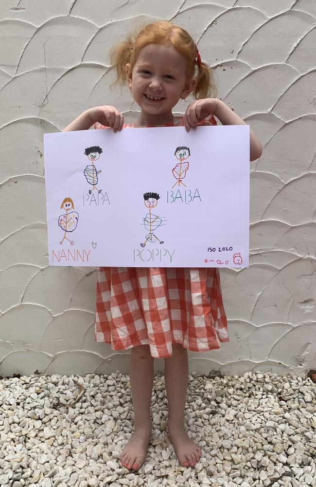 Imogen Pearson, 4, in Townsville with a drawing of love for her grandparents. Picture: Supplied.