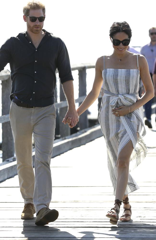 Prince Harry holding hands with Meghan Markle who was cradling her small baby bump. Picture: AP Photo/Kirsty Wigglesworth, Pool