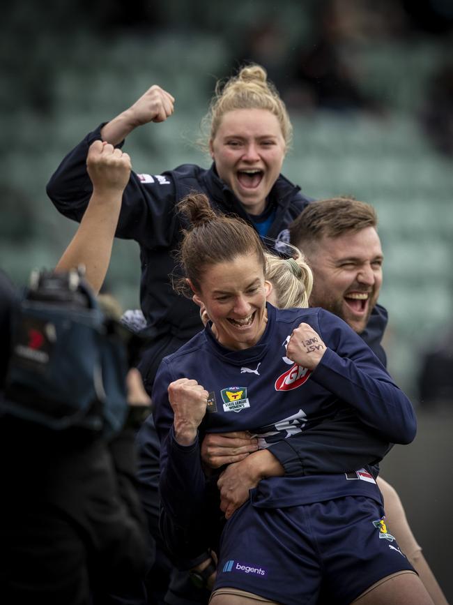 Launceston playing coach Angela Dickson (front) celebrates on the sidelines at the final siren. Picture: LUKE BOWDEN