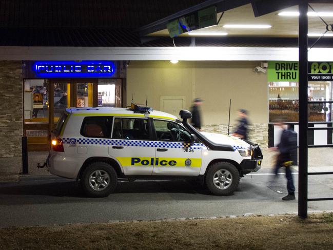 Police visit the Lake Jindabyne Hotel earlier this month.