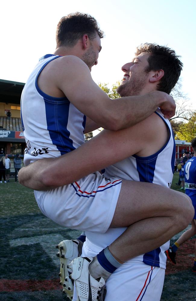 Ruckman Mark Kovacevic and the much smaller Matthew Vincitorio soak up the spoils of their win.