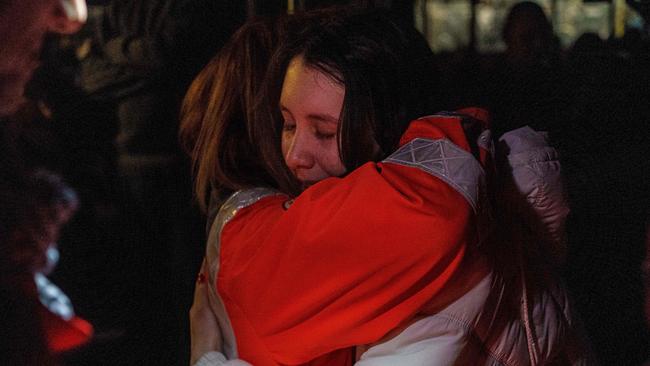 Two women hug as a convoy of 30 buses carrying evacuees from Mariupol and Melitopol arrive in Zaporizhzhia. Picture: AFP