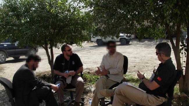 Former Australian Federal Police Detective Sergeant Kjell Brennemo with partner Michael Duthie mentoring a member of the Afghanistan Counter Narcotics Police with the help of a local translator. Picture: supplied