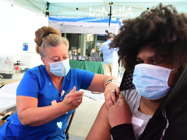 Registered Nurse Amy Berecz-Ortega from AltaMed Health Services administers the Pfizer Covid-19 vaccine in Los Angeles, California on August 17, 2021. - LA County health officials will begin offering third doses of the Pfizer and Moderna Covid-19 vaccines for people with severely compromised immune systems this weekend. The CDC has revealed about 1.1 million people have already gotten a third dose of the Pfizer or Moderna vaccines on their own, although it remains unclear how many did so due to their weakened immune systems. (Photo by Frederic J. BROWN / AFP)