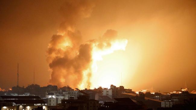 Fire and smoke rise above buildings during an Israeli air strike in Gaza City. Israeli Prime Minister Benjamin Netanyahu vowed to reduce Hamas's Gaza hideouts to "rubble".