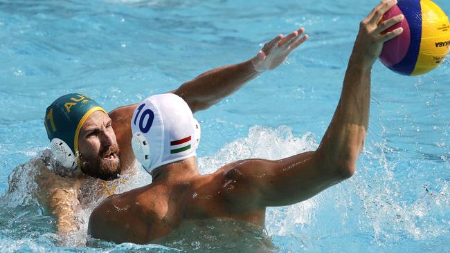 Hungary's Denes Varga, right, takes a shot as Australia's Rhys Howden.