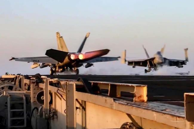 US Navy F/A-18 fighter aircraft operate on an aircraft carrier at sea reportedly during operations against Yemen Huthi rebels