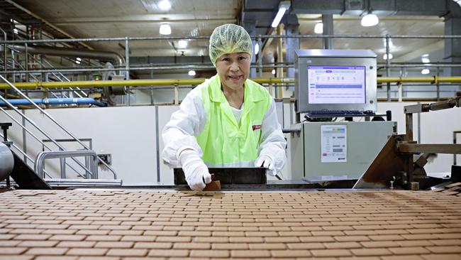 Ying Ye quality testing the Tim Tam biscuit base at the Arnott’s factory. Picture: Adam Yip