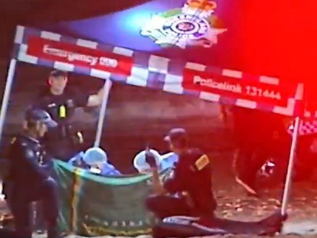 Police at the scene of an infant found dead on a Gold Coast beach at Surfers Paradise