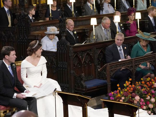 Princess Eugenie and her new husband Jack Brooksbank, look back towards the Duke of York and Sarah, Duchess of York and Queen Elizabeth II, among other members of the royal family. Picture: Getty Images