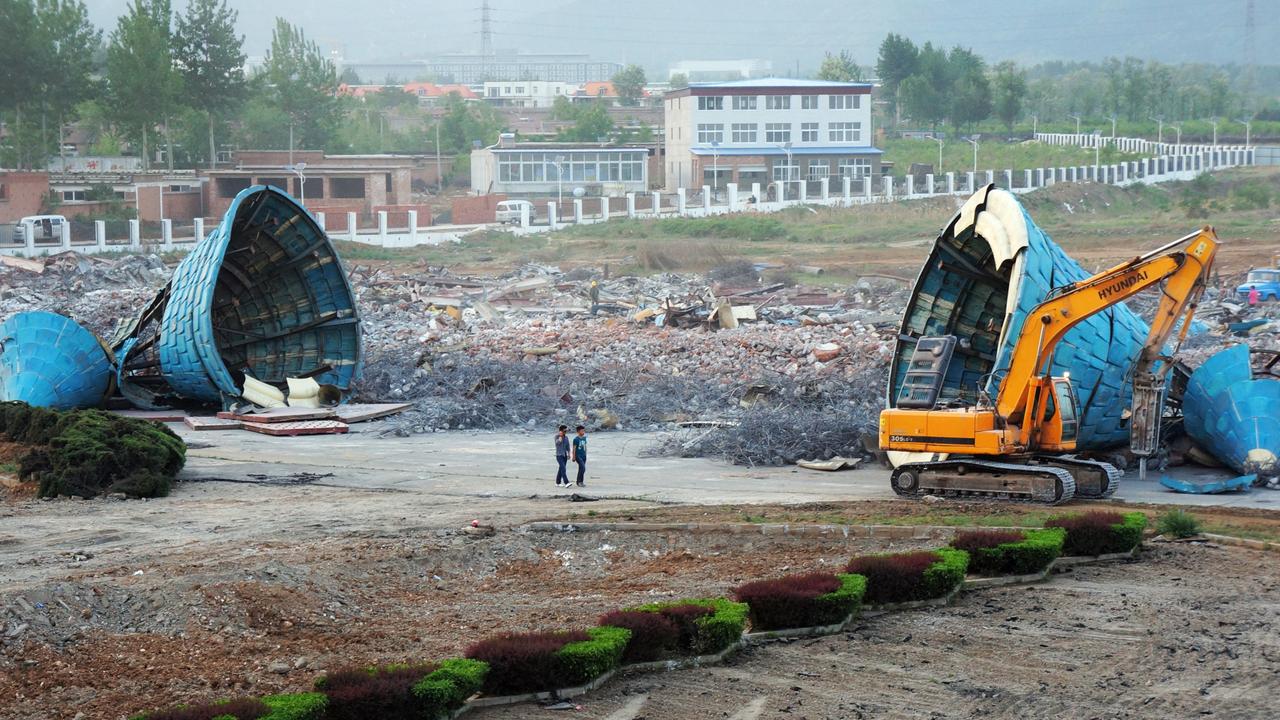 Chinese workers work at the now abandoned Wonderland in China. Picture: Imaginechina Limited / Alamy