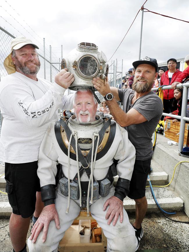 Peter McMahon is assisted into an old diving suit by Simon Lessels and Pat Rogers at the Australian Wooden Boat Festival in 2019. Picture: Richard Jupe