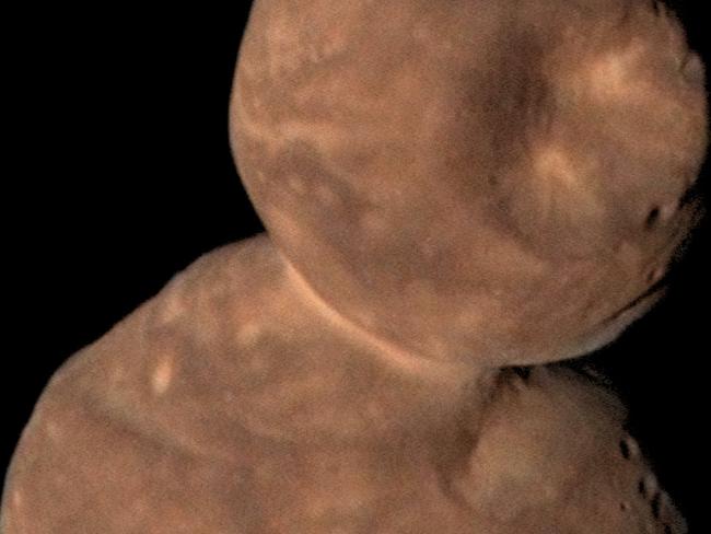 This Jan. 1, 2019 image from NASA shows Arrokoth, the farthest, most primitive object in the Solar System ever to be visited by a spacecraft. Astronomers reported Thursday, Feb. 13, 2020 that this pristine, primordial cosmic body photographed by the New Horizons probe is relatively smooth with far fewer craters than expected. It's also entirely ultrared, or highly reflective, which is commonplace in the faraway Twilight Zone of our solar system known as the the Kuiper Belt. (NASA/Johns Hopkins University Applied Physics Laboratory/Southwest Research Institute/Roman Tkachenko via AP)