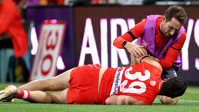 Paddy McCartin receives attention from a trainer after hitting his head. Picture: Brendon Thorne/AFL Photos/via Getty Images