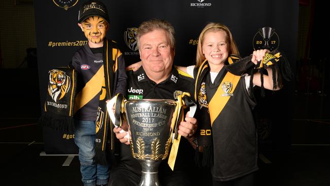 Tiger fan Zac, Richmond football manager Neil Balme and young Brianna, with the soon to be rested 2017 premiership cup. Picture: Lawrence Pinder