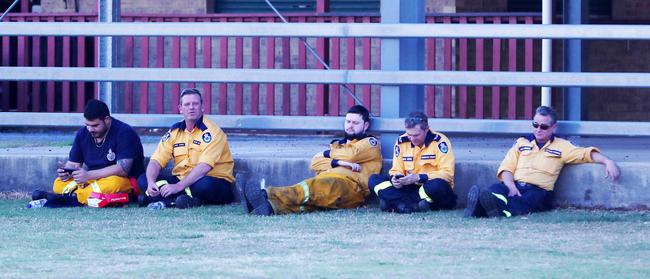 Firefighters take a rare break from battling blazes in the Gold Coast hinterland. Picture: Nigel Hallett