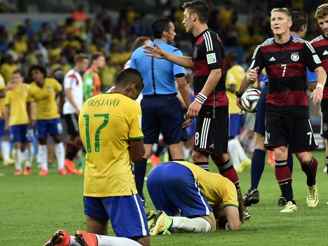 Brazil players sink to their knees after the World Cup semifinal soccer match between Brazil and Germany at the Mineirao Stadium in Belo Horizonte, Brazil, Tuesday, July 8, 2014. Germany won the match 7-1. (AP Photo/Martin Meissner)