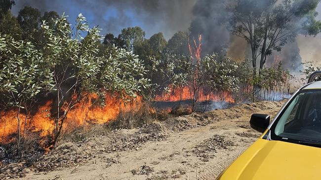 Members of the Purono Rural Fire Brigade battle to contain a bushfire to the north of Townsville over the weekend. Picture: Purono Rural Fire