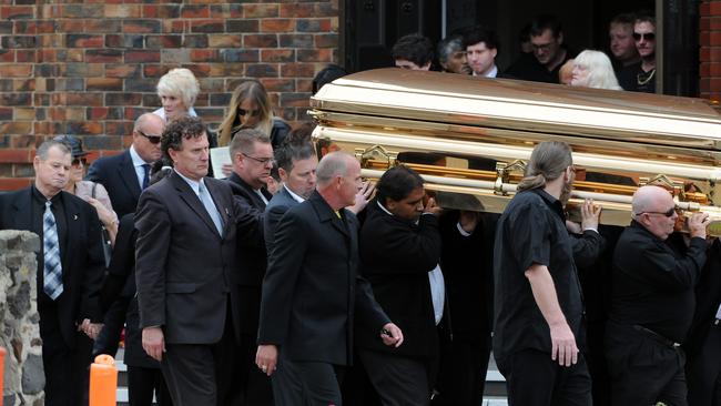 Carl’s golden coffin leaves church followed by his father George.